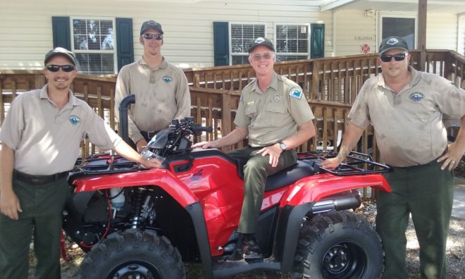 Park staffers admire the new Honda ATV acquired with funds from the FOF annual fund campaign. From left to right are: park services specialist Steve Houseknecht, ranger Steven Bass, biologist Mike Owen and ranger Tom Mosley.